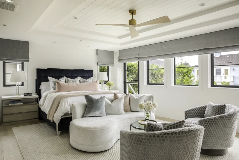 Full remodel master bedroom with tray ceiling and curved sofa in Newport Beach — 28 Cape Andover