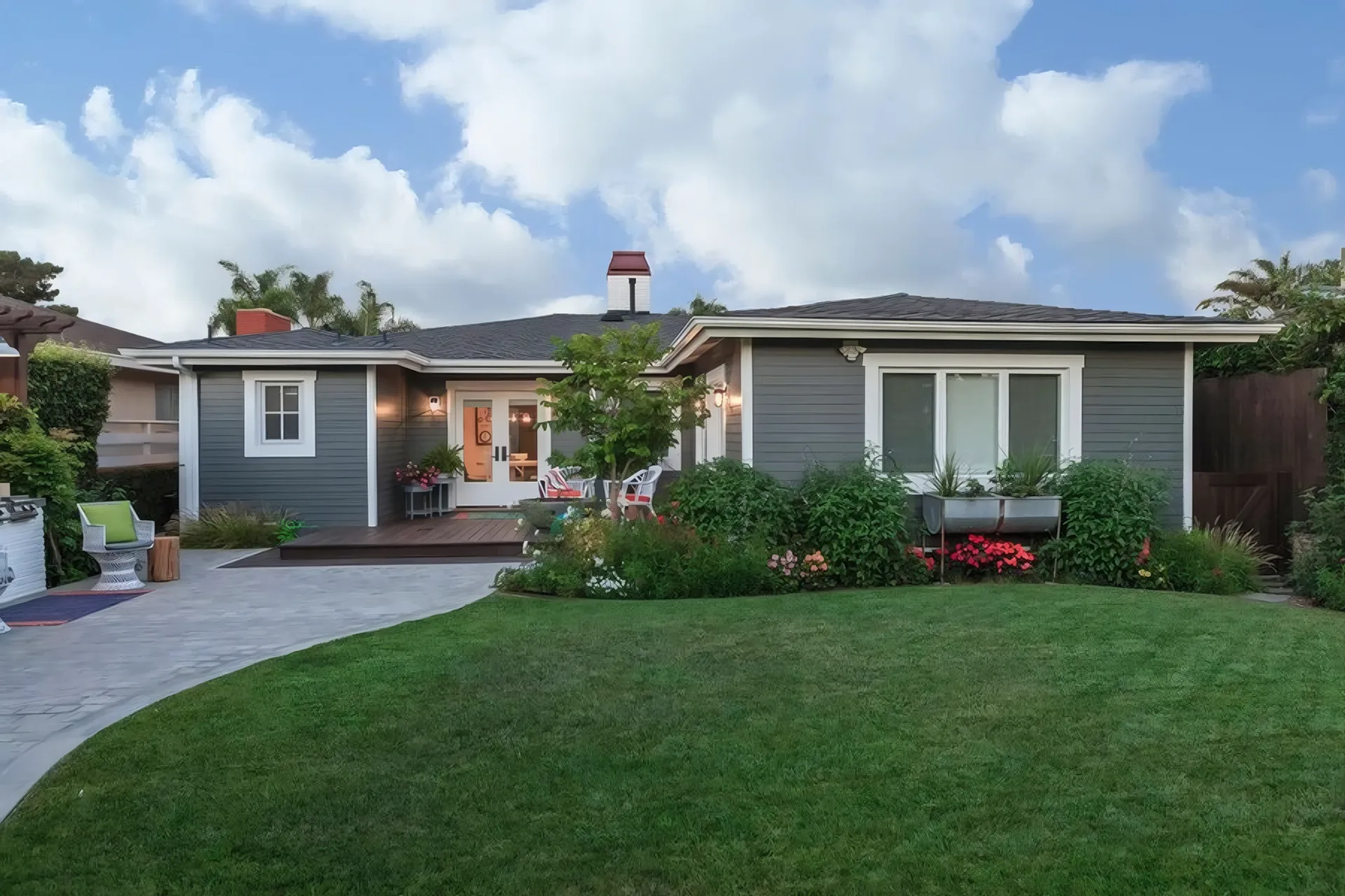 Modern Huntington Beach home exterior with manicured garden and entry porch