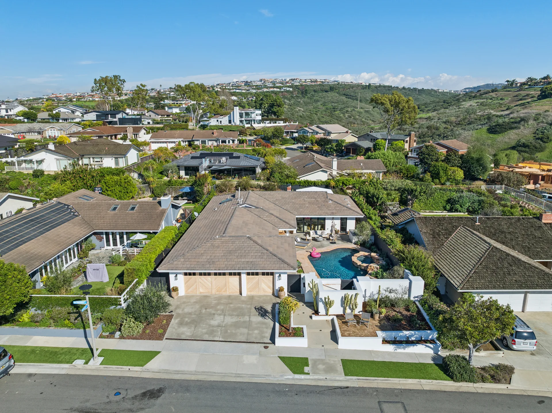 Aerial view of a completed Corona del Mar home and pool by Drake Construction